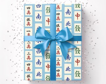 May include: A wrapped gift with light blue paper featuring a pattern of Mahjong tiles in red, green, and black. The gift is tied with a light blue satin ribbon and bow. The text "Horde Mentality" is in the upper right corner.