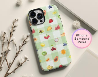 May include: A green and white phone case with a checkered pattern and colorful fruit illustrations. The case is compatible with iPhone, Samsung, and Pixel phones.