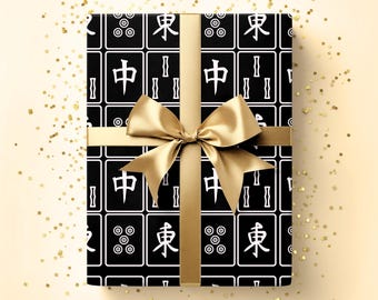 May include: A wrapped gift with black wrapping paper featuring white Chinese characters and symbols. The gift is tied with a gold ribbon and bow. The words "Horde Mentality" are in the top right corner.