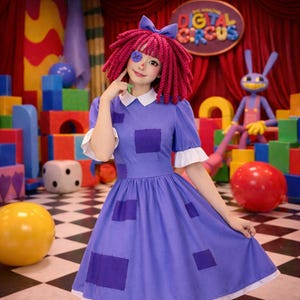 May include: A person in a purple dress with square patches, white collar and cuffs, and a red wig with a blue bow. The background includes colourful toy blocks and a sign that says "DIGITAL CIRCUS".
