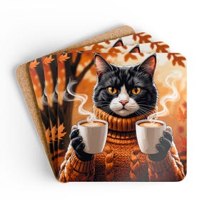 May include: Set of four square coasters featuring a black and white cat wearing an orange sweater and holding two cups of coffee. The background shows an autumn scene with orange leaves and trees. The coasters have a cork backing.