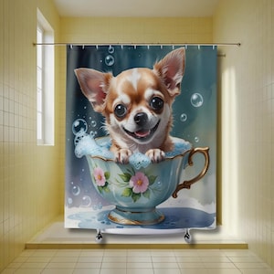 May include: A shower curtain featuring a smiling Chihuahua dog in a teacup filled with bubbles. The teacup is light blue with gold trim and pink floral accents. The background is a watercolor wash of blue and white.