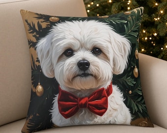May include: A square throw cushion featuring a white dog with a red bow tie centred against a dark background of green pine branches and gold ornaments. The dog has fluffy white fur, dark eyes, and a black nose, creating a festive holiday scene.