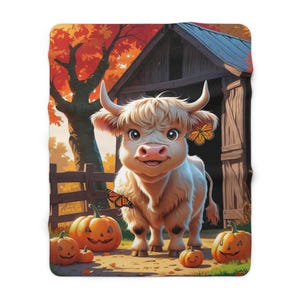 Cute happy highland cow with jack-o-lanterns by the barn Fleece Blanket fall home decor, Halloween bedroom for kids, fun autumn family room