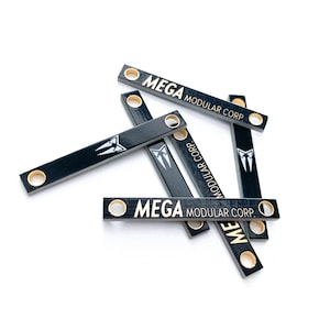 May include: A set of three ceramic mugs with a speckled, matte finish. The mugs are in shades of cream, light gray, and dark gray. Each mug has a simple, minimalist design and a rounded handle.