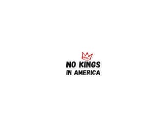 May include: A white sticker with the text "NO KINGS IN AMERICA" in black, with a red crown above the text. The sticker has a white border.