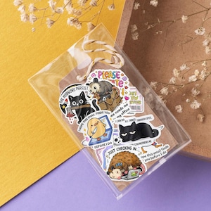 a collection of cartoon animal stickers, including a cat, a dog, and a bird, arranged on a clear plastic surface.