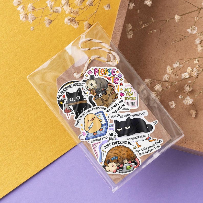 a collection of cartoon animal stickers, including a cat, a dog, and a bird, arranged on a clear plastic surface.
