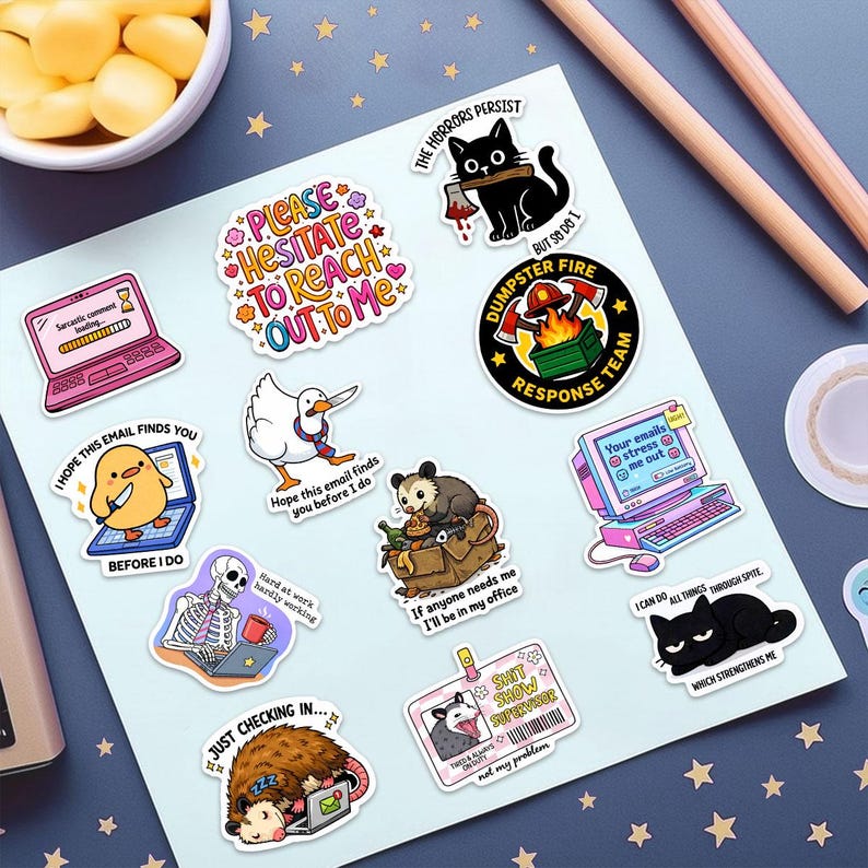 a collection of colorful stickers with various cartoon-style illustrations, including a cat, a bird, a laptop, and other whimsical objects. The stickers are arranged on a white background, with some placed on a desk and others on a table.