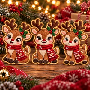 May include: Three embroidered reindeer patches featuring brown fur, large eyes, and red scarves with the name Emily and white snowflake patterns. Each reindeer has dark brown antlers and a small sprig of green holly with red berries on one ear.