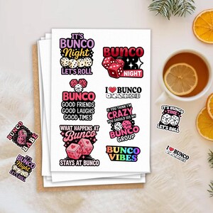 May include: A collection of colorful Bunco-themed stickers with dice and text. The stickers feature phrases like "Bunco Night," "Good Friends, Good Laughs, Good Times," and "What Happens at Bunco Stays at Bunco." A cup of tea with a lemon slice is also visible.