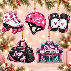 May include: Five acrylic ornaments featuring roller skating themes: white skates labeled Bella, a pink helmet labeled Chloe, black and pink knee pads labeled Aria, a black duffel bag labeled Luna, and a roller rink building labeled Stella.