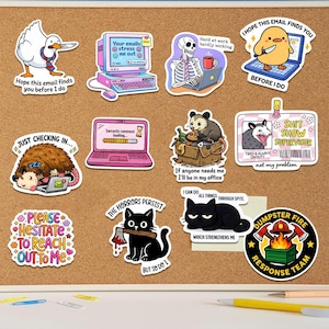 a collection of cartoon-style stickers with various humorous and informative messages. The stickers are arranged on a corkboard or bulletin board, and there are some pens and a keyboard visible in the background.