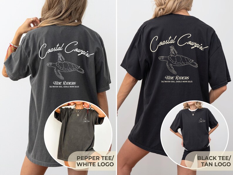 May include: Two oversized t-shirts with a graphic of a sea turtle and the text "Coastal Cowgirl Tide Riders Saltwater Soul Saddle Worn Soles". The left shirt is a pepper color with a white logo and the right shirt is black with a tan logo.
