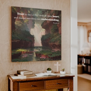 May include: A rectangular wall art print featuring a landscape painting of a river flowing between rocky cliffs with lush green vegetation. The text reads: Trust in the LORD with all thine heart; and lean not unto thine own understanding. Proverbs 3:5.