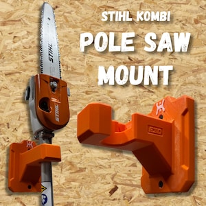 May include: An orange STIHL Kombi pole saw mount. The mount is designed to hold a pole saw and is made of durable plastic. The text "STIHL KOMBI POLE SAW MOUNT" is displayed in white block letters.