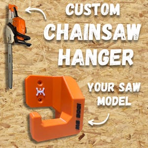 May include: An orange chainsaw hanger with the text "CUSTOM CHAINSAW HANGER" and "YOUR SAW MODEL". The hanger is designed to hold a chainsaw, which is also shown in the image. The hanger has a hook shape and is mounted on a wooden surface.