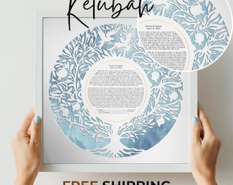 May include: A framed Ketubah with a white border. The artwork features a circular design with a tree and floral cutouts, and a blue watercolor background. The text "Ketubah" is written in cursive at the top.