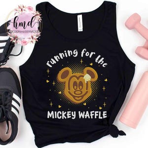 May include: Black tank top with the text "running for the MICKEY WAFFLE" and a Mickey Mouse waffle graphic. The image includes black sneakers, pink dumbbells, and a pink water bottle.