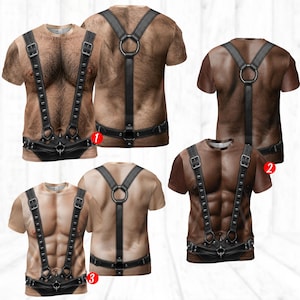 May include: A collection of short-sleeved t-shirts featuring realistic 3D prints of muscular torsos with varying skin tones and hair density. Each shirt displays a graphic of a black leather harness with metal buckles, studs, and rings.