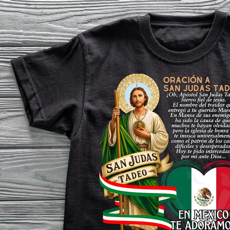 May include: Black t-shirt featuring an illustration of Saint Jude Thaddeus, holding a staff, with text in Spanish. The design includes the Mexican flag and the words "San Judas Tadeo" and "En Mexico Te Adoramos."
