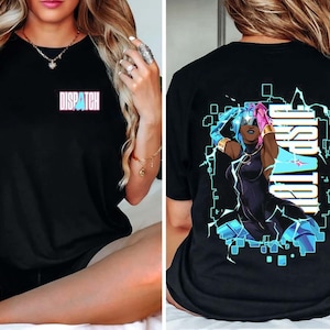 May include: Black t-shirt with the word "DISPATCH" in a pink and blue font on the front. The back of the shirt features a graphic of a woman with blue and pink hair, surrounded by a blue and white geometric design.