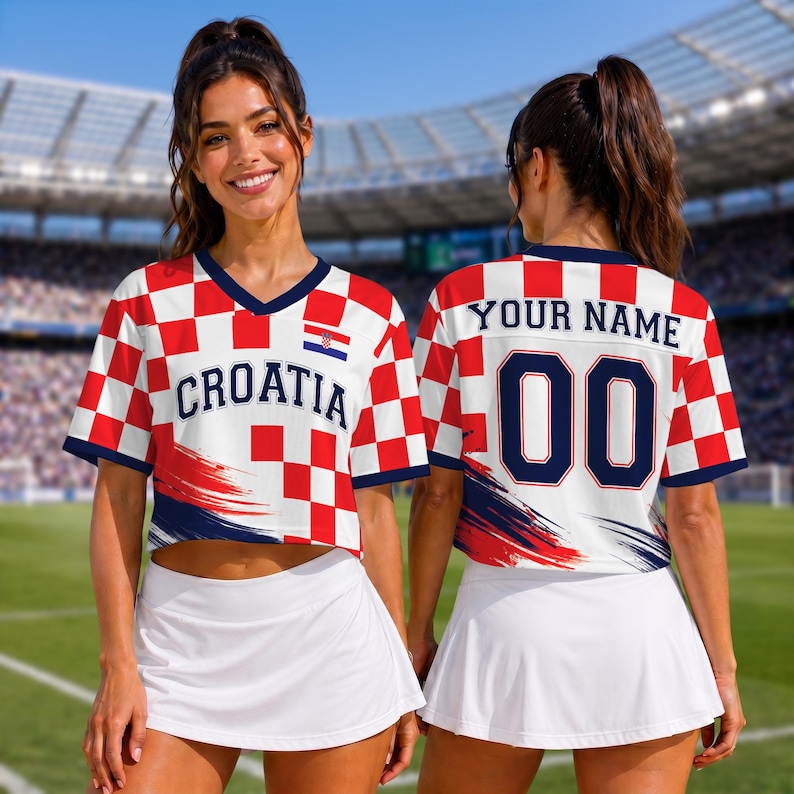 May include: A cropped V-neck jersey featuring a red and white checkered pattern, the text CROATIA on the front, and a small Croatian flag emblem. The back displays the text YOUR NAME above the number 00, with navy blue accents and brush strokes.