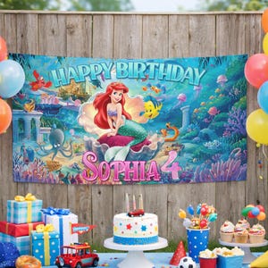 May include: A rectangular party banner featuring a colorful underwater scene with the character Ariel from The Little Mermaid, the text Happy Birthday, and the name Sophia 4. The banner is displayed against a wooden fence background.