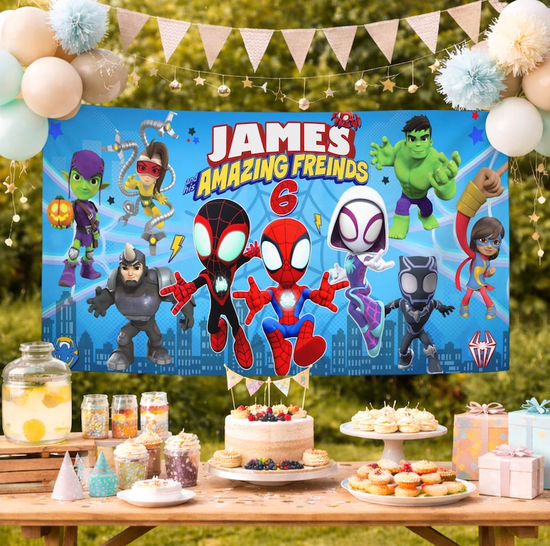 May include: A rectangular blue party banner featuring cartoon characters including Spider-Man, Hulk, and Black Panther with the text James and his Amazing Freinds 6. The banner is displayed above a table with a cake, treats, and gift boxes.