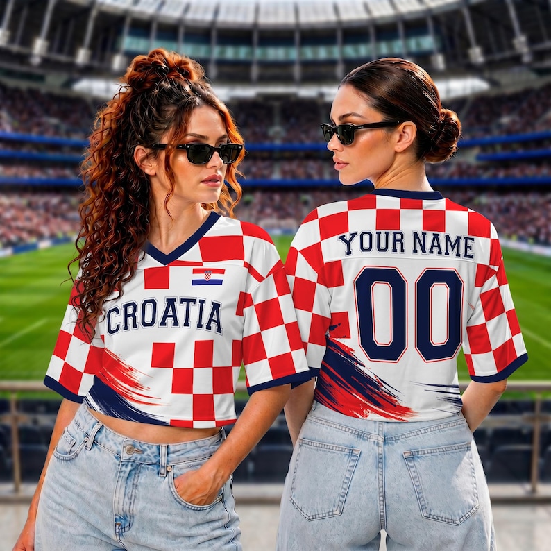 May include: A short-sleeved jersey featuring a red and white checkerboard pattern, the text "CROATIA" on the front, and "YOUR NAME" with the number "00" on the back. The design includes a small Croatian flag emblem and navy blue accents.