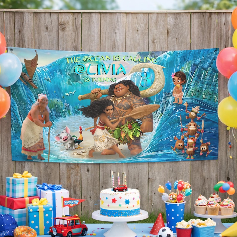 May include: A rectangular party banner featuring a Moana-themed graphic with a large ocean wave, characters including Moana, Maui, and Pua, and the text THE OCEAN IS CALLING OLIVIA IS TURNING 3. The banner is displayed against a wooden fence background.