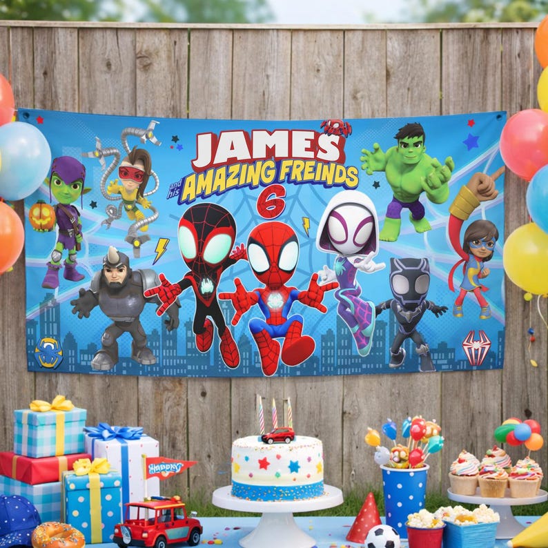 May include: A rectangular blue party banner featuring the text 'JAMES and his AMAZING FREINDS' and the number '6'. The banner displays cartoon illustrations of various superheroes including Spider-Man, Ghost-Spider, Hulk, and Black Panther.