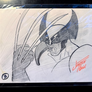 May include: A black and white pencil sketch on paper featuring a character with a mask and three long claws extending from a fist. The character has an open mouth and a signature in red ink in the bottom right corner with the number 3 in a circle.