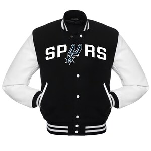 May include: Black and white varsity jacket with the word "SPURS" in white block letters across the chest. The jacket features white sleeves, a black body, and a team logo. The jacket has a button-up front and two front pockets.