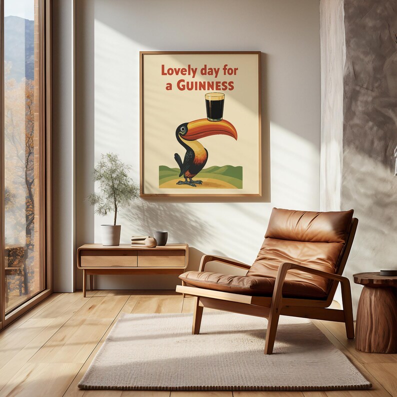 May include: A framed vintage-style poster with a toucan holding a Guinness pint. The poster reads "Lovely day for a Guinness" in red text. The toucan has a large orange beak and is set against a cream background.