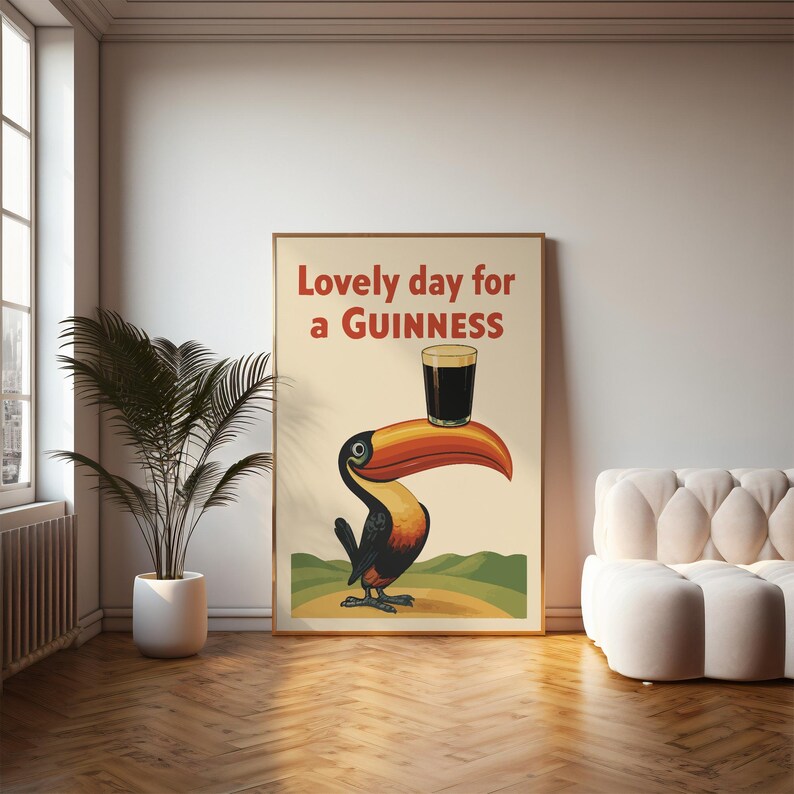 May include: A framed vintage-style poster featuring a toucan holding a pint of Guinness. The poster has the text "Lovely day for a Guinness" in red. The toucan is black, orange, and yellow, with a large beak.