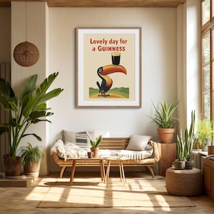 May include: A framed print featuring a toucan balancing a pint of Guinness on its beak. The artwork has a vintage style with the text "Lovely day for a Guinness" in red and green. The toucan is black, orange, and yellow.