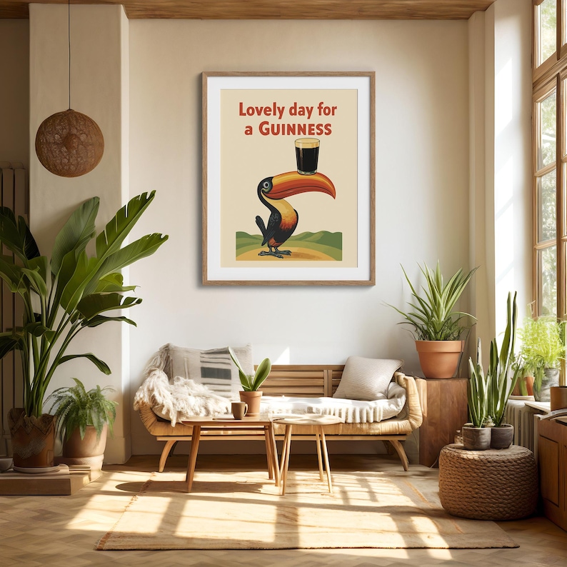 May include: A framed print featuring a toucan balancing a pint of Guinness on its beak. The artwork has a vintage style with the text "Lovely day for a Guinness" in red and green. The toucan is black, orange, and yellow.
