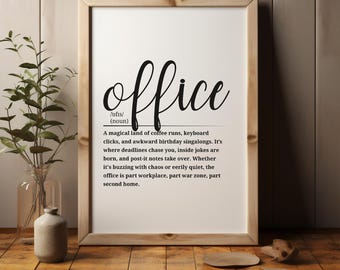 May include: A framed print with the word "office" in a stylish script font. The definition of "office" is below the word, describing it as a place of coffee runs, inside jokes, and deadlines. The frame is light brown, and the background is white.
