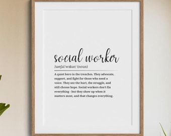May include: A framed print with the words "social worker" in elegant script. Below, the definition of a social worker is provided, describing their role in advocating, supporting, and fighting for those in need. The frame is a warm brown color.