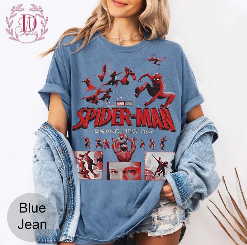 May include: Blue t-shirt featuring the Spider-Man logo and graphics from Marvel Studios. The design includes multiple images of Spider-Man in action poses, with the text "SPIDER-MAN BRAND NEW DAY" in red.