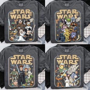 May include: Four gray Star Wars graphic t-shirts. Each shirt features a different design with Star Wars characters and the Star Wars logo in a retro style. The shirts have a vintage, worn look.