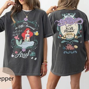 May include: A set of three ceramic mugs with a speckled, matte finish. The mugs are in shades of cream, light gray, and dark gray. Each mug has a simple, minimalist design, perfect for coffee or tea.