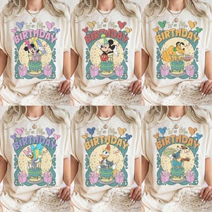 May include: Cream-colored t-shirts with various cartoon characters and the text "It's My Birthday." Designs include Mickey Mouse, Minnie Mouse, Pluto, Daisy Duck, Donald Duck, and Goofy, each with a birthday cake.