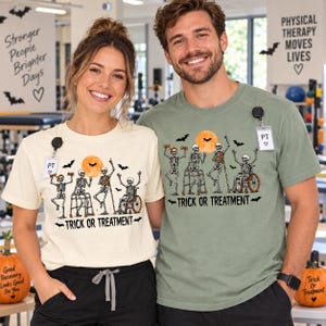 May include: A cream-colored t-shirt and a sage green t-shirt, both featuring a graphic of four skeletons exercising with a full moon and bats. The text "TRICK OR TREATMENT" is printed below the skeletons on both shirts. Each shirt has a PT badge.