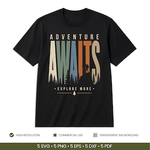 May include: A black short-sleeve t-shirt featuring a graphic design with the text ADVENTURE AWAITS in large, multi-colored, distressed-style letters. Below the text is a silhouette of a hiker on a mountain peak with pine trees and EXPLORE MORE.