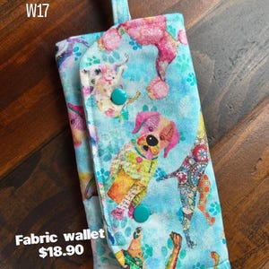 Fabric Wallet with zipper compartment, 6 card slots, and 1 hidden pockets. 7 1/2" long x 4" wide. Padded. Washable and Lightweight