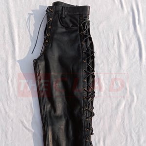 May include: Black leather pants with a lace-up detail on the side seam.
