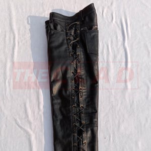 May include: Black leather pants with a lace-up detail on the side seam.