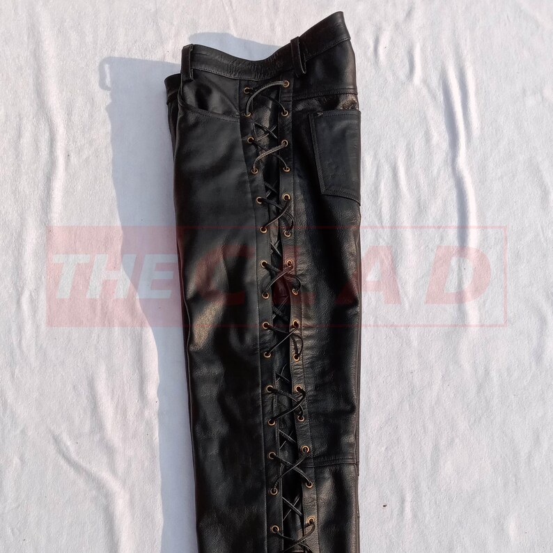 May include: Black leather pants with a lace-up detail on the side seam.